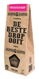 Spicy salt licorice in a brown paper bag with the text "De Beste Drop" (The Best Licorice) and a licorice candy icon.