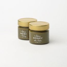 Honey with Matcha - A jar of honey infused with the earthy, grassy flavor of matcha green tea powder. The honey has a rich, golden color and a smooth, creamy texture.