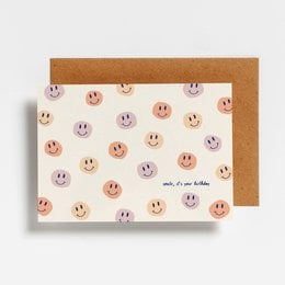 Colorful smiley face postcard with the text "Smile it's your birthday" on a cream-colored background.