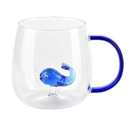  A 400ml mug with a blue whale design. The mug has a clear glass body and a blue handle.