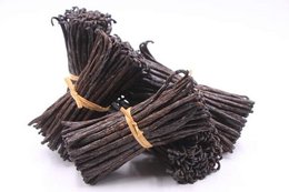 Dark brown vanilla beans, bundled and tied with a golden string. Gourmet-quality bourbon vanilla pods, suitable for seasoning and baking.