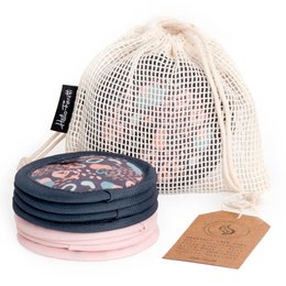 Reusable makeup remover pads in a mesh bag, featuring a floral pattern and black pads for removing makeup.