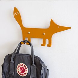 Orange fox-shaped wall hook for hanging kids' clothing and accessories. Made of durable metal with a playful design.
