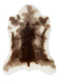 A large, plush reindeer-patterned rug with a soft, fuzzy texture and a neutral color palette.