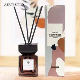 Reed diffuser with essential aroma oil, 100 ml, in a glass bottle with black reed sticks.
