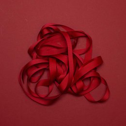 Dark red ribbon with "My Pretty Circus" text. Decorative ribbon for gift wrapping or crafting.