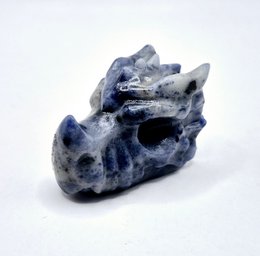 Sodalite dragon skull, a decorative crystal item made of the blue-gray mineral sodalite, with a distinctive dragon-like shape.