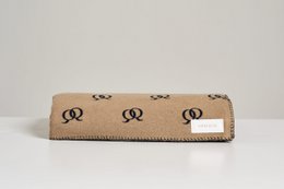 Soft, cozy blanket in a navy blue color with a repeating pattern of gold-colored symbols.