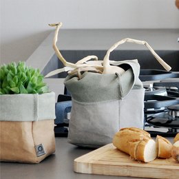 Long forma paper bags in various colors including havana, sand, grey, sage green, turquoise, and brown. The bags have a rectangular shape and are made of durable paper material.