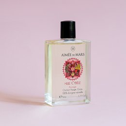 Natural anointing oil in a glass bottle with a floral label, suitable for face and body use.