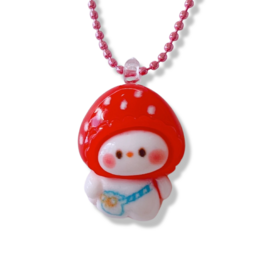 A red and white polka dot pendant necklace with a cute mushroom-shaped character. The necklace has a pink beaded chain.