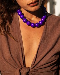  Bold purple beaded necklace with a modern, stylish design.