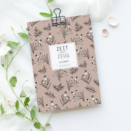 "Wall calendar with a floral pattern and the text 'Zeit zum Zeug' (Time for stuff). The calendar features a variety of nature-inspired designs and colors, making it a versatile and stylish addition to any home or office."