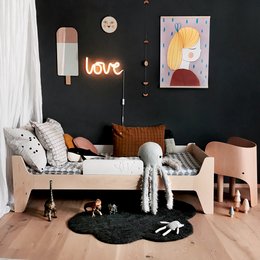 A wooden junior bed with a white and cocoa color scheme, featuring a simple and modern design suitable for a child's bedroom.