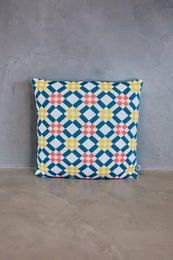 Decorative cushion cover with a vibrant geometric pattern in shades of blue, yellow, and white. Made of high-quality materials for a comfortable and stylish addition to any living space.