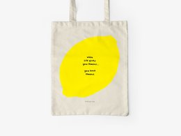 A cotton tote bag with a large yellow circular graphic and the text "You Have Lemons" printed on it. The bag is made of natural cotton material and has sturdy handles for carrying.