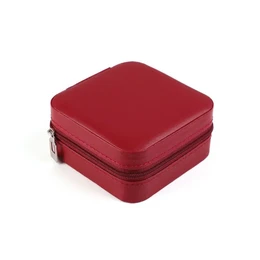 A red square jewelry box with a zipper closure. The box is designed for storing and transporting jewelry while traveling.