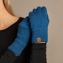 Knitted wool gloves in blue, dark gray, black, and creamy beige colors. Warm and cozy winter accessories.