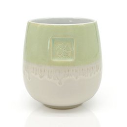  Green glazed ceramic cup with shamrock motif, suitable for holding various items like pens, pencils, or small plants.