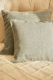 Turquoise cotton dhurrie square cushion cover, textured weave, neutral tones, decorative pillow.