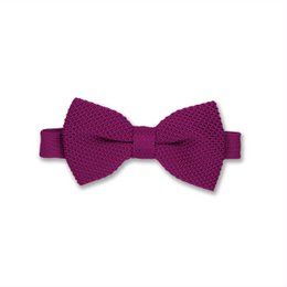 Berry pink knitted bow tie, made of soft, textured material with a classic bow tie shape.