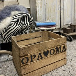 Wooden storage crate with "Opa & Oma" text, suitable for storing various items. The crate has a rustic, vintage appearance and is made of natural wood materials.