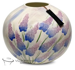  A round, tall vase with a floral pattern featuring shades of purple and blue. The vase has a smooth, glossy finish and appears to be made of ceramic or porcelain.