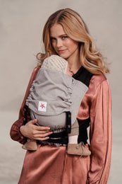 Gray baby carrier with adjustable straps and padded back support for comfortable carrying.