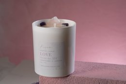 Scented crystal candle with "LOVE" label, round shape, white color.