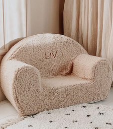 Beige plush chair with embroidered name "LIV" for kids, featuring a cozy and comfortable design.