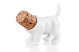 White ceramic dog-shaped bottle stopper with cork body. Decorative wine accessory.