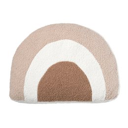 A decorative pillow with a rainbow-like design in neutral tones of beige, camel, and white. The pillow has a soft, plush texture and a curved, abstract shape that resembles a rainbow or arch.