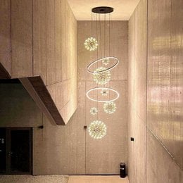 Large, modern LED pendant light with circular, spherical shapes in a chrome or black finish.