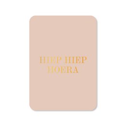  A greeting card with the text "Hip Hip Hooray" in gold foil on a light pink background.