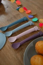Colorful spoon set for kids, featuring a bear design in various pastel shades including ocean, plum, indigo, and cinnamon.