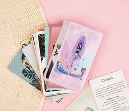 A deck of cards featuring illustrations of various self-care and mindfulness practices, including yoga poses, meditation, and relaxation techniques. The cards are designed to promote stress reduction and overall well-being.