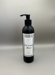 Black and white striped hand soap bottle with a simple label that says "A new home". The bottle has a pump dispenser and appears to be made of glass or a similar material.