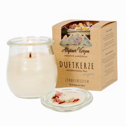 Scented Swiss pine candle in a glass jar with a wooden lid, packaged in a cardboard box. The candle has a warm, earthy aroma and a simple, rustic design.