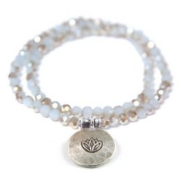 A gray, double lotus bracelet made of beaded charms.
The product is a gray, double lotus bracelet made of beaded charms. The bracelet features a mix of gray, white, and metallic beads, creating a layered and textured look. The charms include a lotus flower symbol, adding a natural and spiritual element to the design. This bracelet would be suitable for casual or semi-formal wear, and could be paired with a variety of outfits.