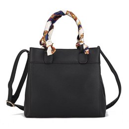  Black and orange leather tote handbag with patterned handles, shoulder strap, structured rectangular shape, available in multiple colors.