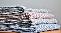 Soft, cozy throw blanket with arrow design pattern in coral, sky, green, and grey colors. Made of 130 x 180 cm size.