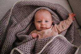  Plush, soft wool crib blanket in a rich plum color. Ideal for keeping baby cozy and comfortable.