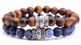 Beaded bracelet set with brown tiger eye and sodalite stones, featuring a textured metal bead.