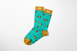  Colorful patterned socks featuring cat and dog paw prints in various colors on a teal background. The socks have a comfortable, stretchy fit and are made of high-quality materials.