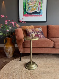  Circular gold-colored side table with a wooden top.