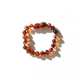 Cognac-colored amber baby bracelet with round beads.