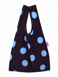 Dark navy shopping bag with light blue polka dots pattern, casual tote style.