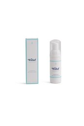 Cleansing mousse in travel size, gentle formula for face and body, packaged in a compact bottle.