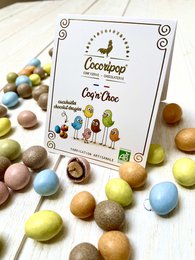  Assorted chocolate-covered nuts and fruits in a variety of colors and shapes, including round, oval, and irregular forms. The product is labeled as "Coq 'n' Choc (cacahuète chocolat dragée)" and is categorized as "Chocolate Covered Fruits".