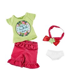 A green t-shirt with a floral graphic, red ruffled shorts, a red headband, and white underwear. This outfit is suitable for a young girl and is part of the "Sofia the Gardener" collection.
